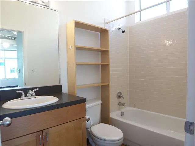 a bathroom with a sink a toilet and bathtub