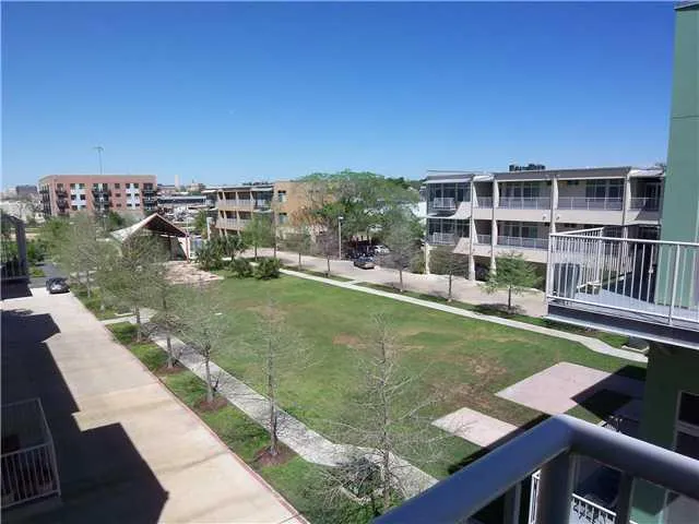 a view of a swimming pool with a bench and lawn chairs