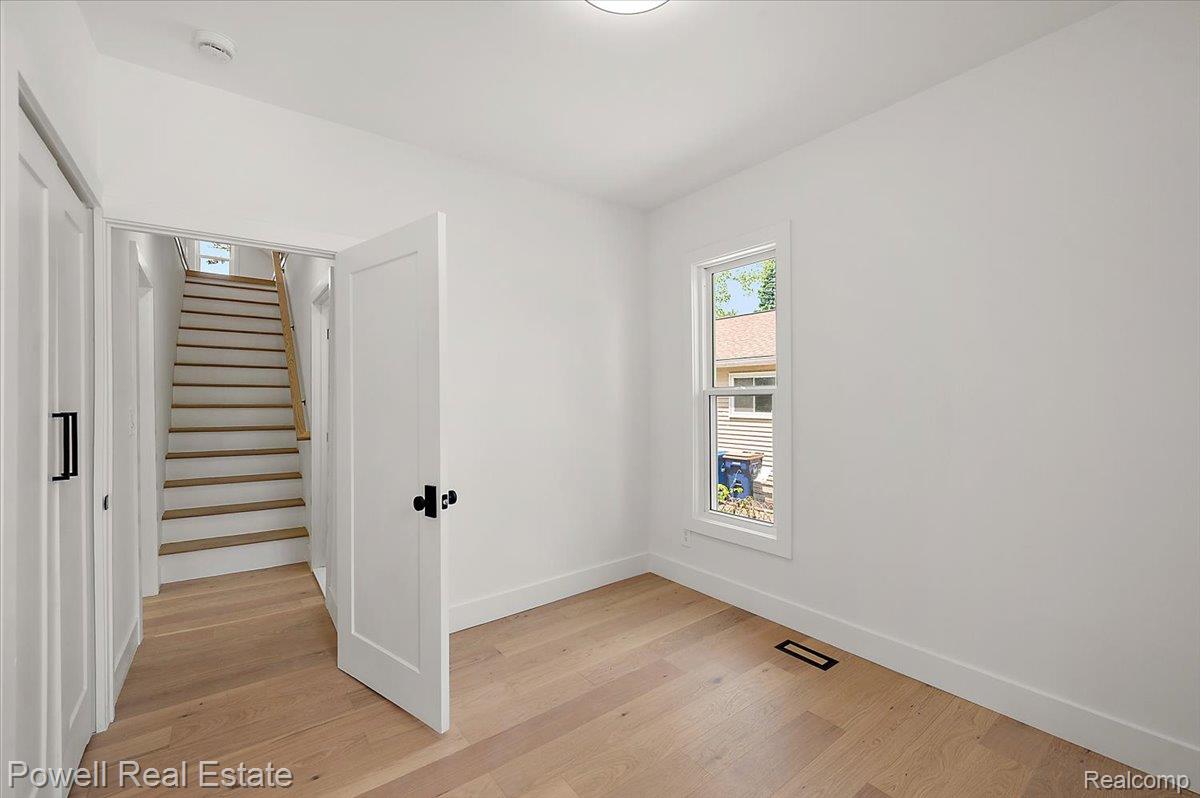 6837 Hatchery Road Waterford, MI 48327 - Photo 26 of 56 Spare room with light wood finished floors and a smoke detector