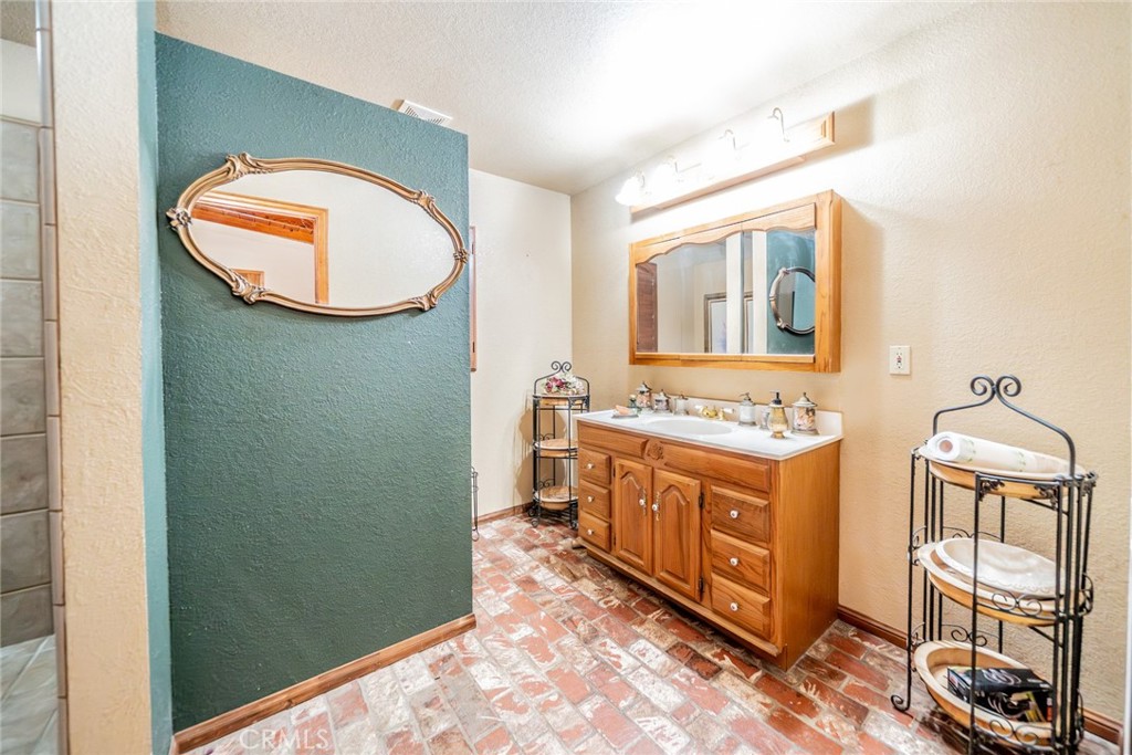 3230 Silver Ridge Drive Pinon Hills, CA 92372 - Photo 11 of 49 a bathroom with a sink and a mirror