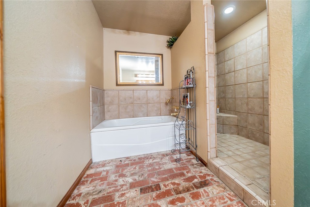 3230 Silver Ridge Drive Pinon Hills, CA 92372 - Photo 12 of 49 a bathroom with a bathtub and shower
