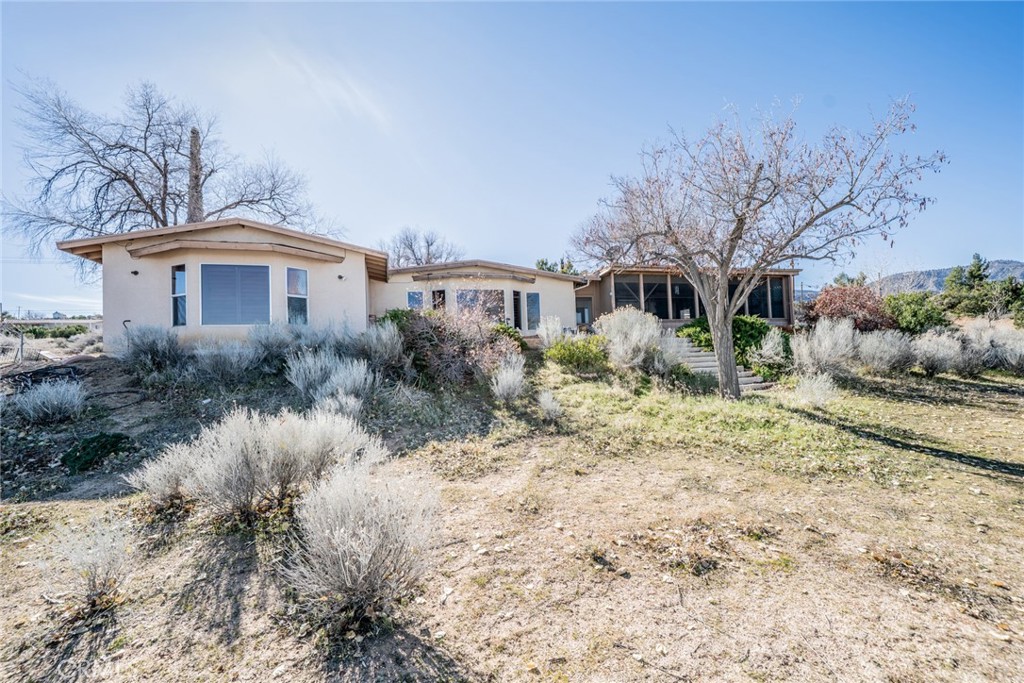 3230 Silver Ridge Drive Pinon Hills, CA 92372 - Photo 4 of 49 a front view of house with yard and trees around