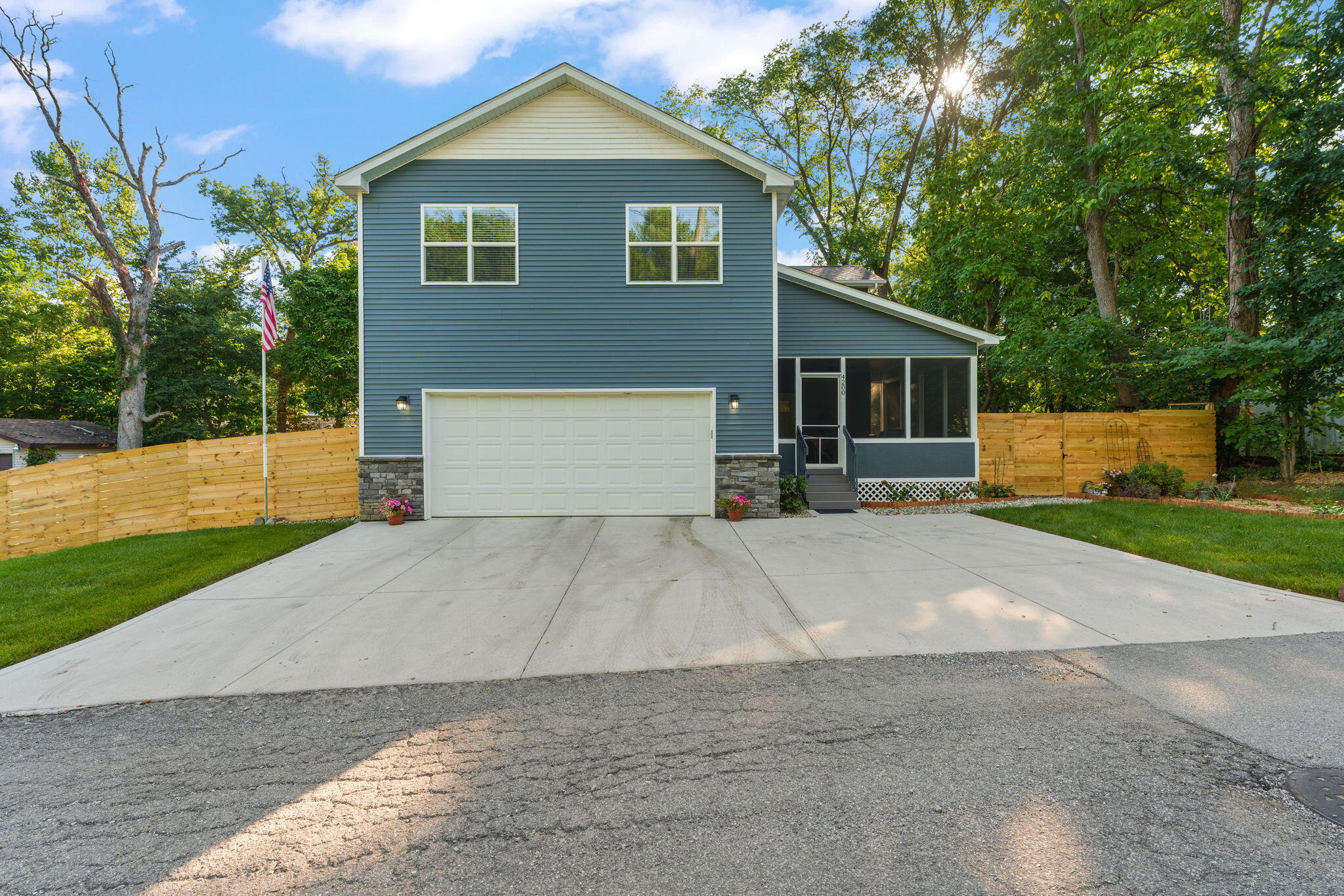 a front view of house with yard and trees