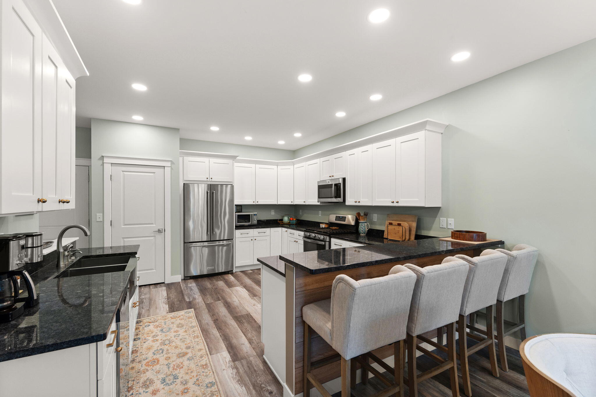 4200 Cardinal Lane Valparaiso, IN 46383 - Photo 12 of 44 a kitchen with stainless steel appliances granite countertop a stove a sink a refrigerator white cabinets and a refrigerator