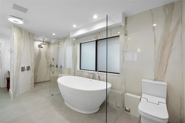 a bathroom with a double vanity sink a large mirror and shower