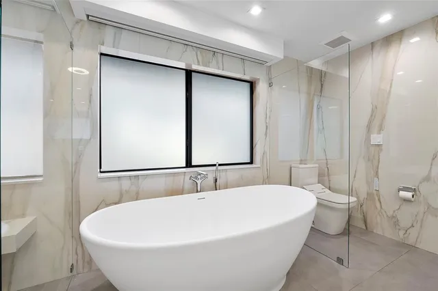 a bathroom with a shower and a sink