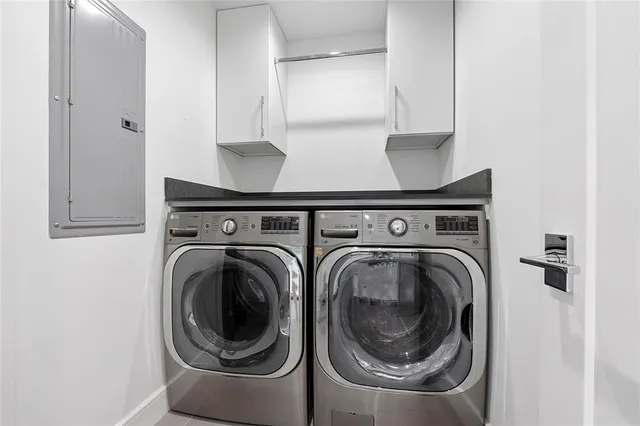 a view of a patio with a table and chairs under an umbrella