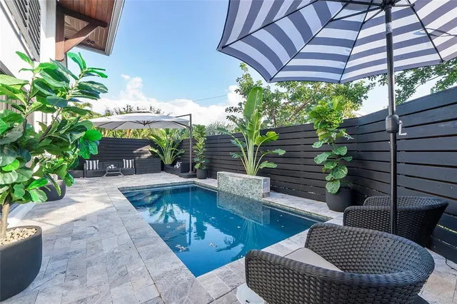 a kitchen with stainless steel appliances granite countertop a sink a counter space and a stove