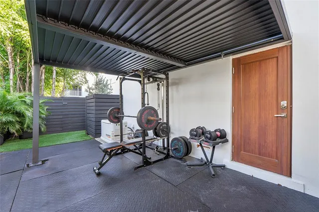 a kitchen with stainless steel appliances granite countertop a refrigerator a stove a sink and white cabinets