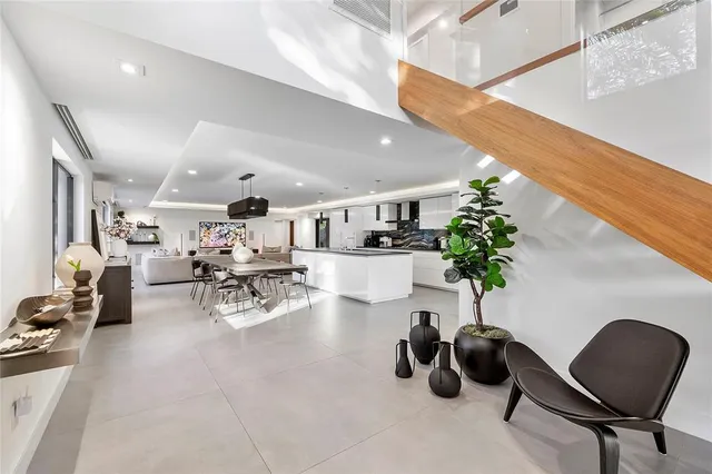 a living room with furniture and potted plant