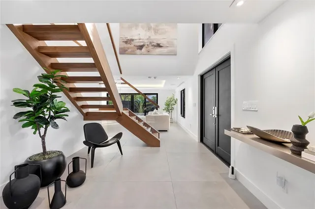 a living room with furniture and a potted plant