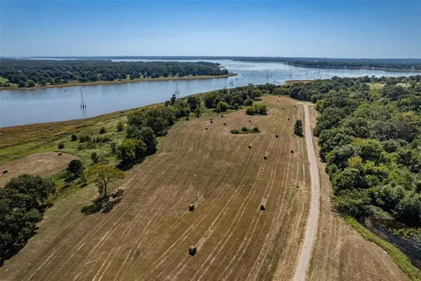 an aerial view of a houses with a lake view