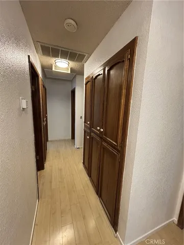 a view of a hallway with wooden floor