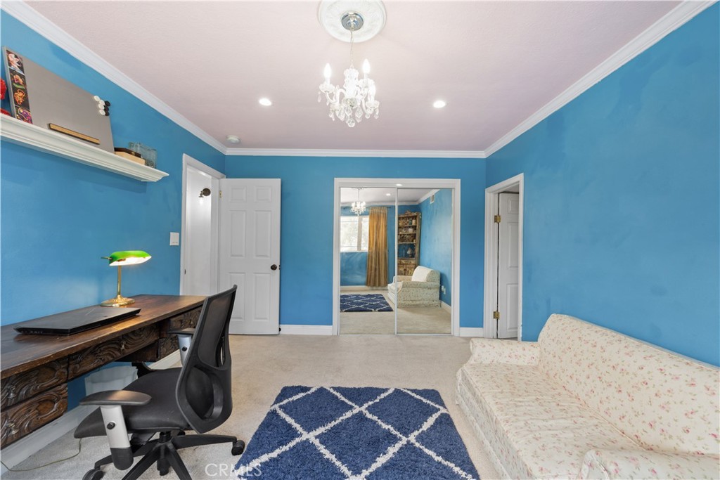 24405 Derian Drive Newhall, CA 91321 - Photo 23 of 44 a bedroom with a bed and a chandelier