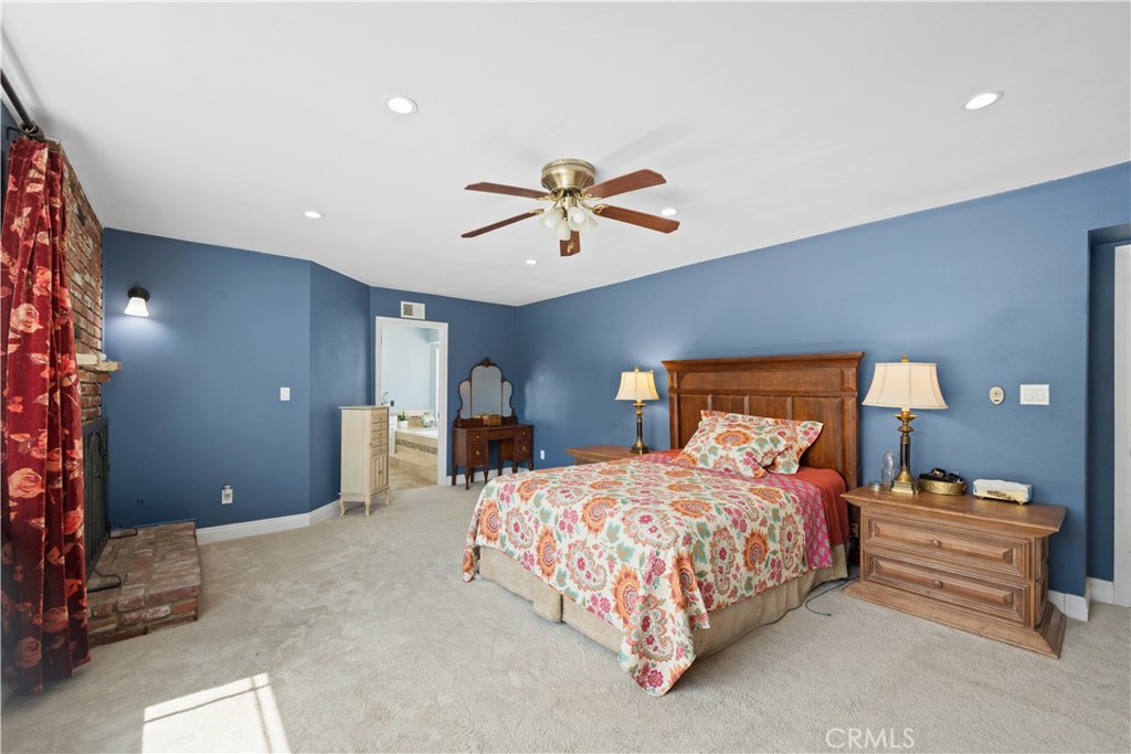 24405 Derian Drive Newhall, CA 91321 - Photo 28 of 44 a bedroom with a bed and a chandelier