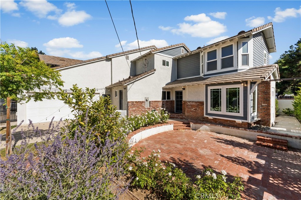 24405 Derian Drive Newhall, CA 91321 - Photo 43 of 44 a front view of a house with a garden