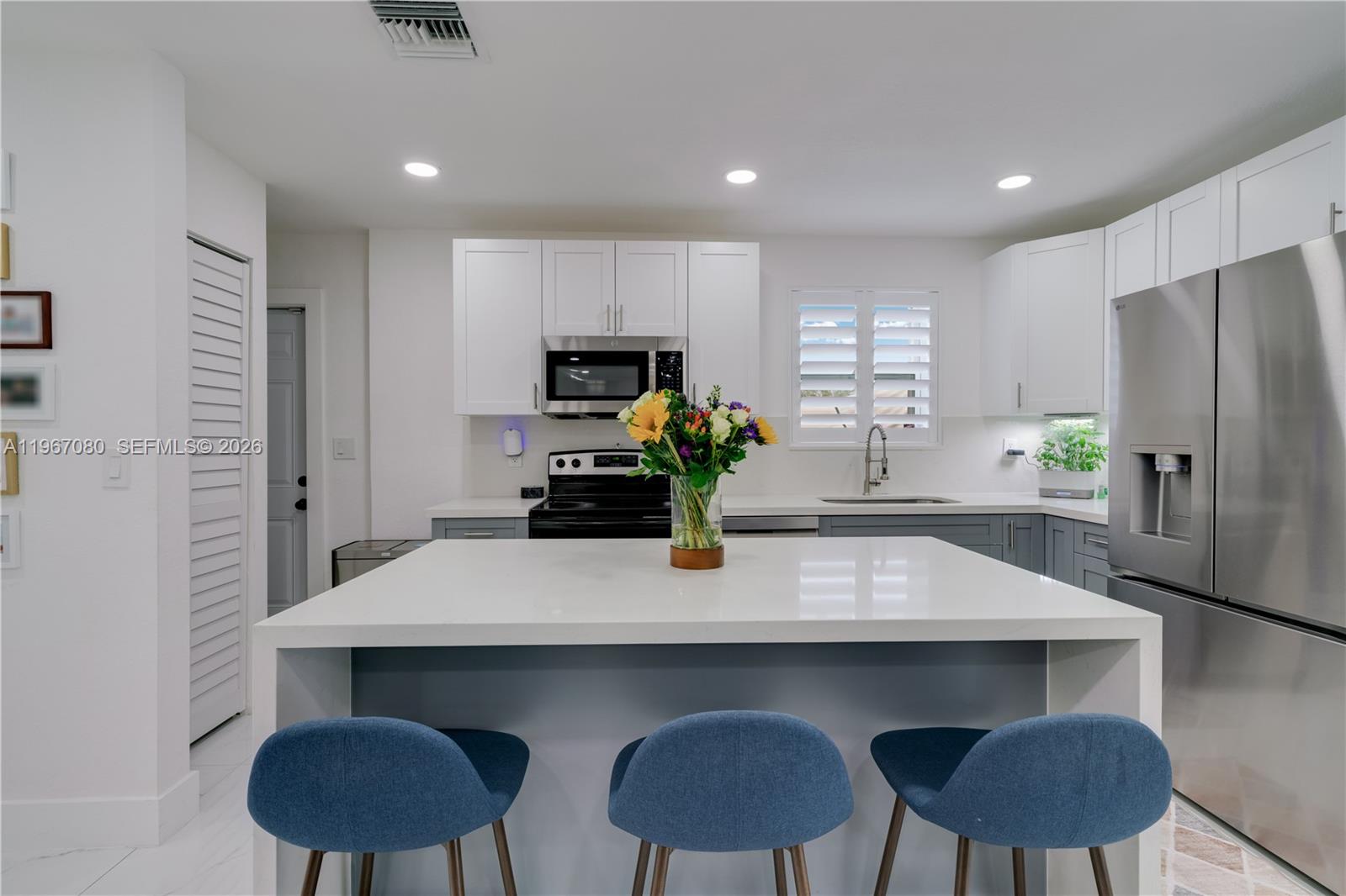 1401 Southwest 94th Avenue Miami, FL 33174 - Photo 11 of 27 a kitchen with a table chairs refrigerator and microwave