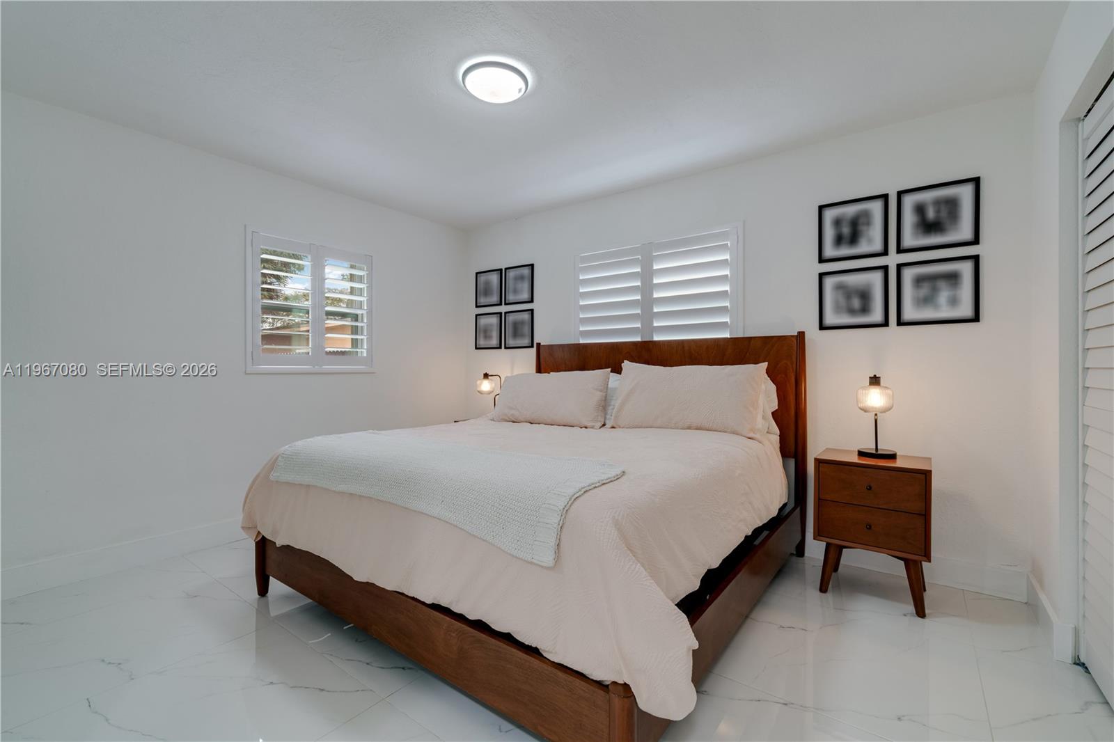 1401 Southwest 94th Avenue Miami, FL 33174 - Photo 17 of 27 a bed sitting in a bedroom next to a window