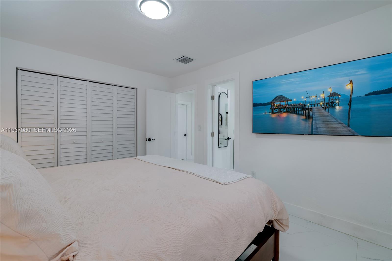 1401 Southwest 94th Avenue Miami, FL 33174 - Photo 18 of 27 a bedroom with a bed and a painting on the wall