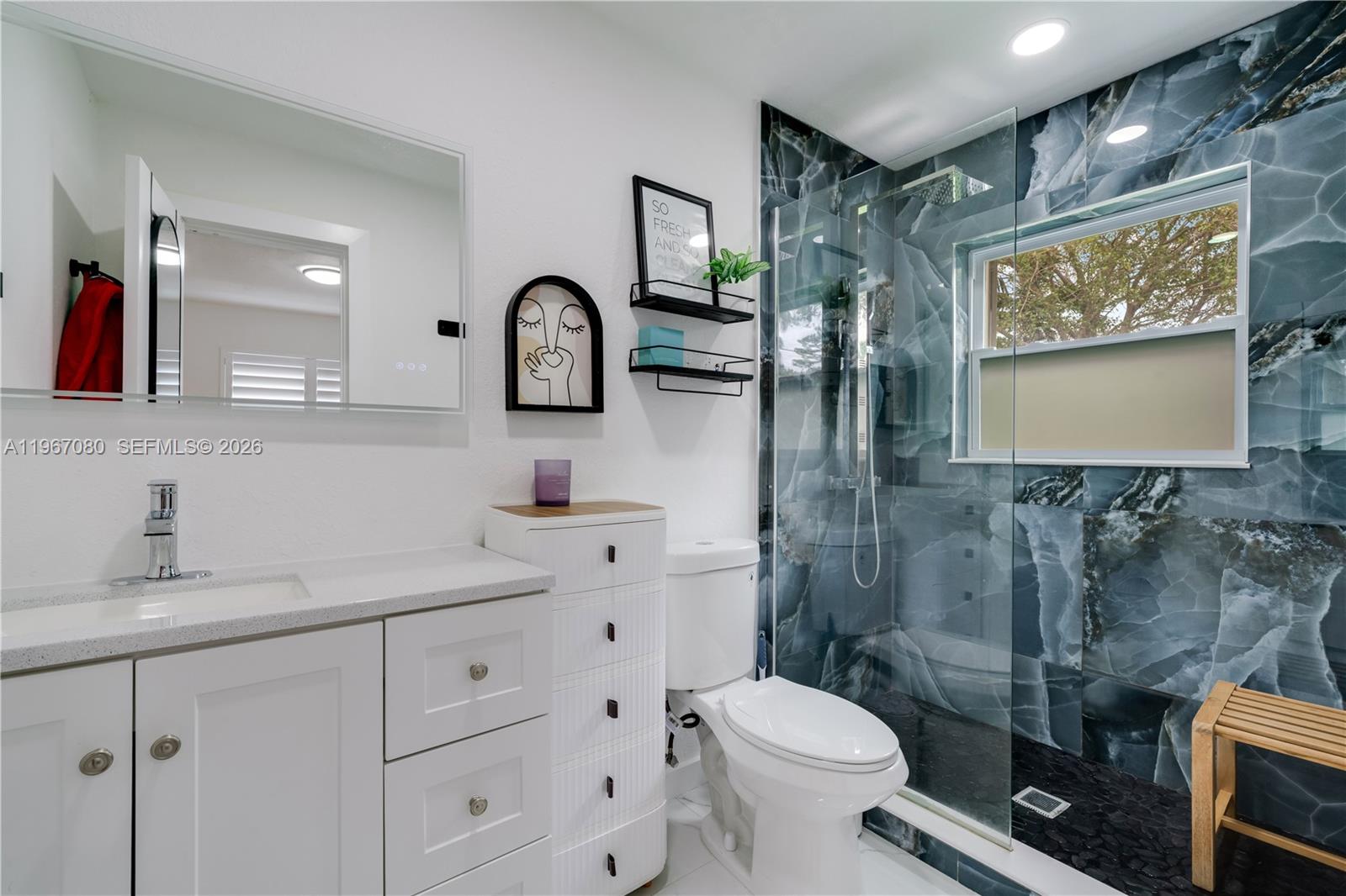 1401 Southwest 94th Avenue Miami, FL 33174 - Photo 19 of 27 a bathroom with a toilet sink and mirror