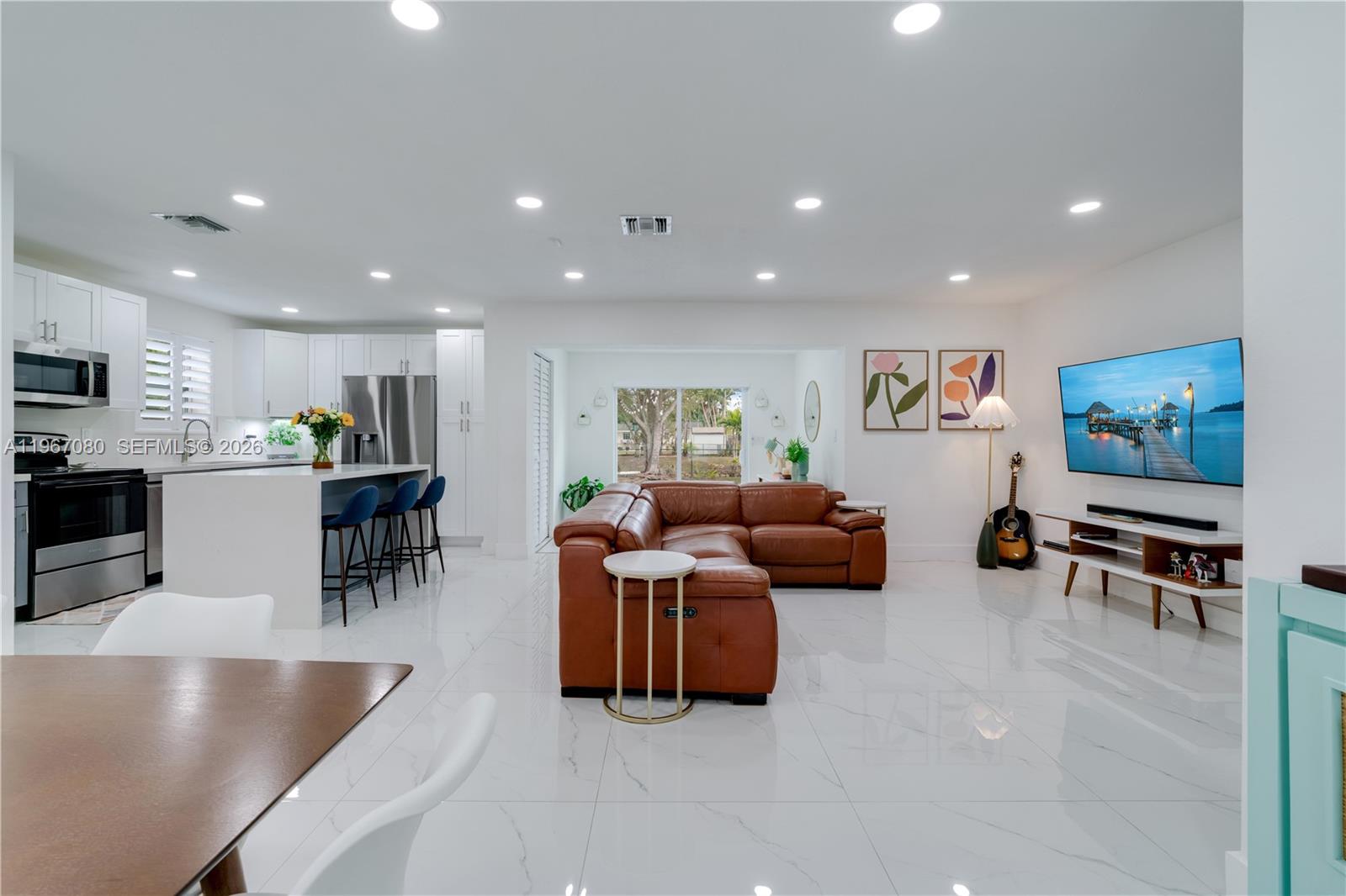 1401 Southwest 94th Avenue Miami, FL 33174 - Photo 5 of 27 a living room with furniture and a flat screen tv