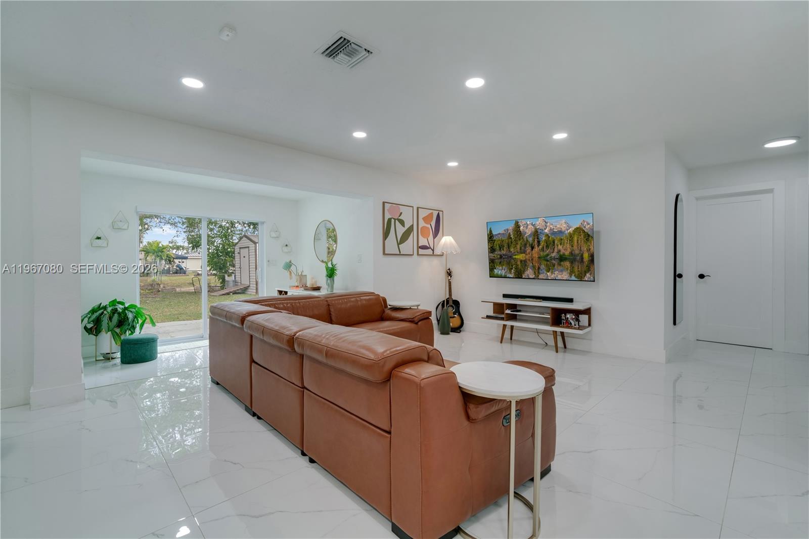 1401 Southwest 94th Avenue Miami, FL 33174 - Photo 8 of 27 a living room with furniture and a flat screen tv