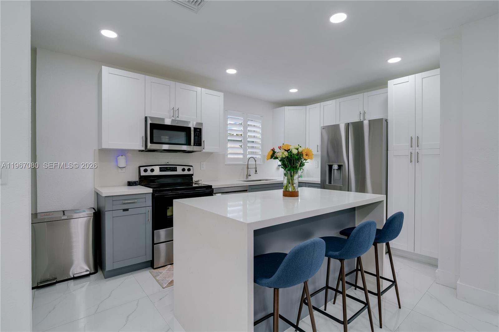 1401 Southwest 94th Avenue Miami, FL 33174 - Photo 10 of 27 a kitchen with stainless steel appliances a refrigerator stove microwave and cabinets