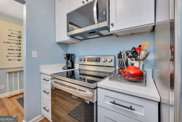 a kitchen with a microwave and cabinets