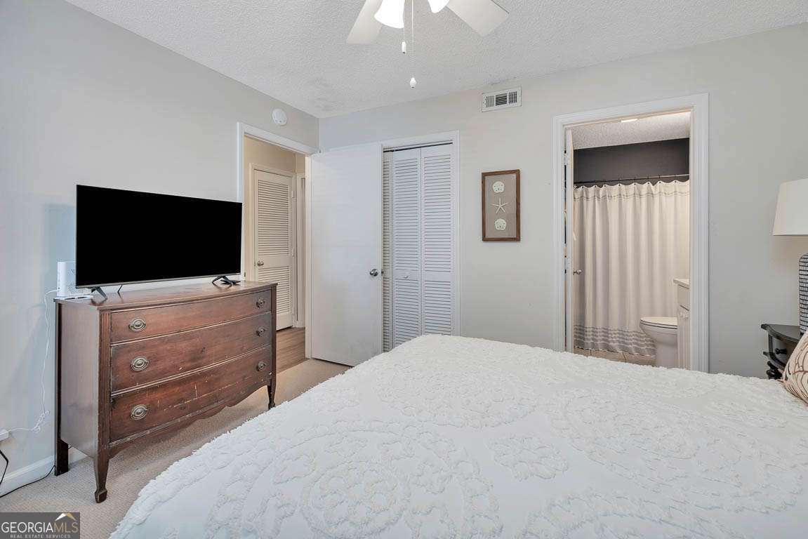 143 South Island Square Drive St. Simons, GA 31522 - Photo 16 of 26 a bedroom with a bed and a flat screen tv