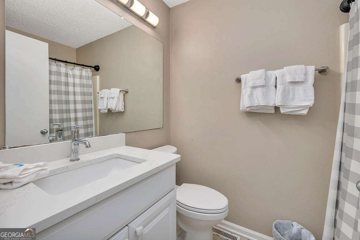 143 South Island Square Drive St. Simons, GA 31522 - Photo 18 of 26 a bathroom with a sink mirror vanity and toilet