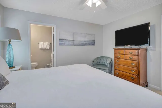 a bedroom with a bed and a flat screen tv in it