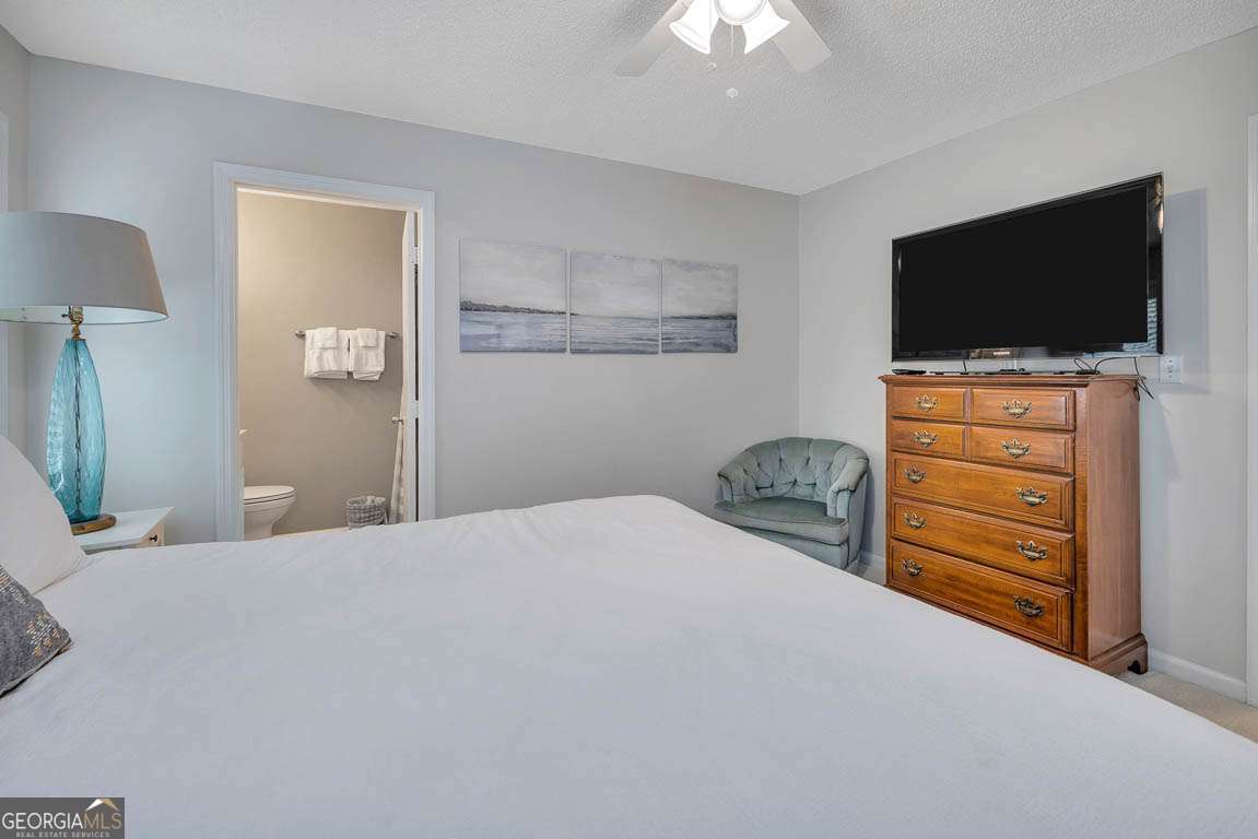 143 South Island Square Drive St. Simons, GA 31522 - Photo 20 of 26 a bedroom with a bed and a flat screen tv in it