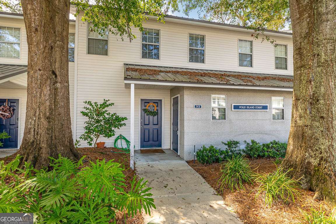 143 South Island Square Drive St. Simons, GA 31522 - Photo 2 of 26 a front view of a house with garden
