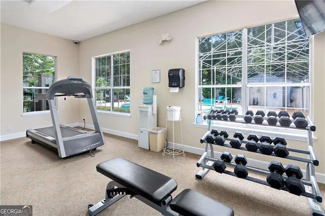 a room with gym equipment and a large window