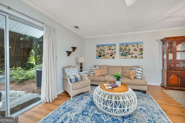 a living room with furniture and a floor to ceiling window
