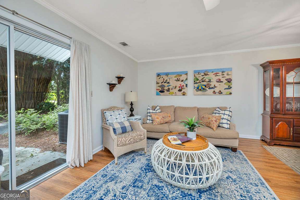 143 South Island Square Drive St. Simons, GA 31522 - Photo 5 of 26 a living room with furniture and a floor to ceiling window