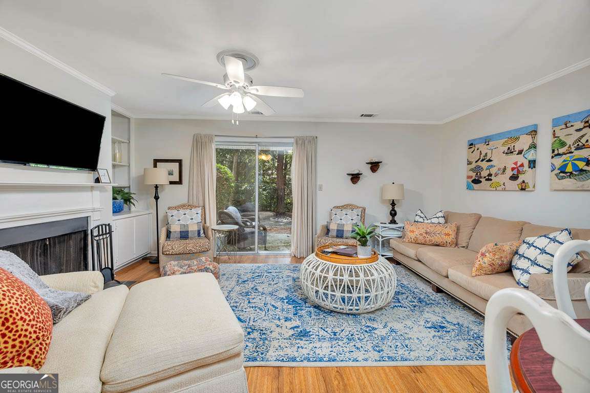 143 South Island Square Drive St. Simons, GA 31522 - Photo 7 of 26 a living room with furniture a fireplace and a flat screen tv