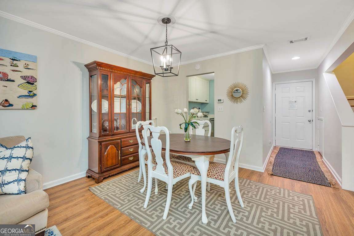 143 South Island Square Drive St. Simons, GA 31522 - Photo 8 of 26 a view of a dining room with furniture and chandelier