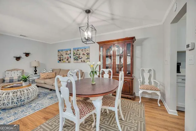 a view of a dining room with furniture wooden floor and chandelier