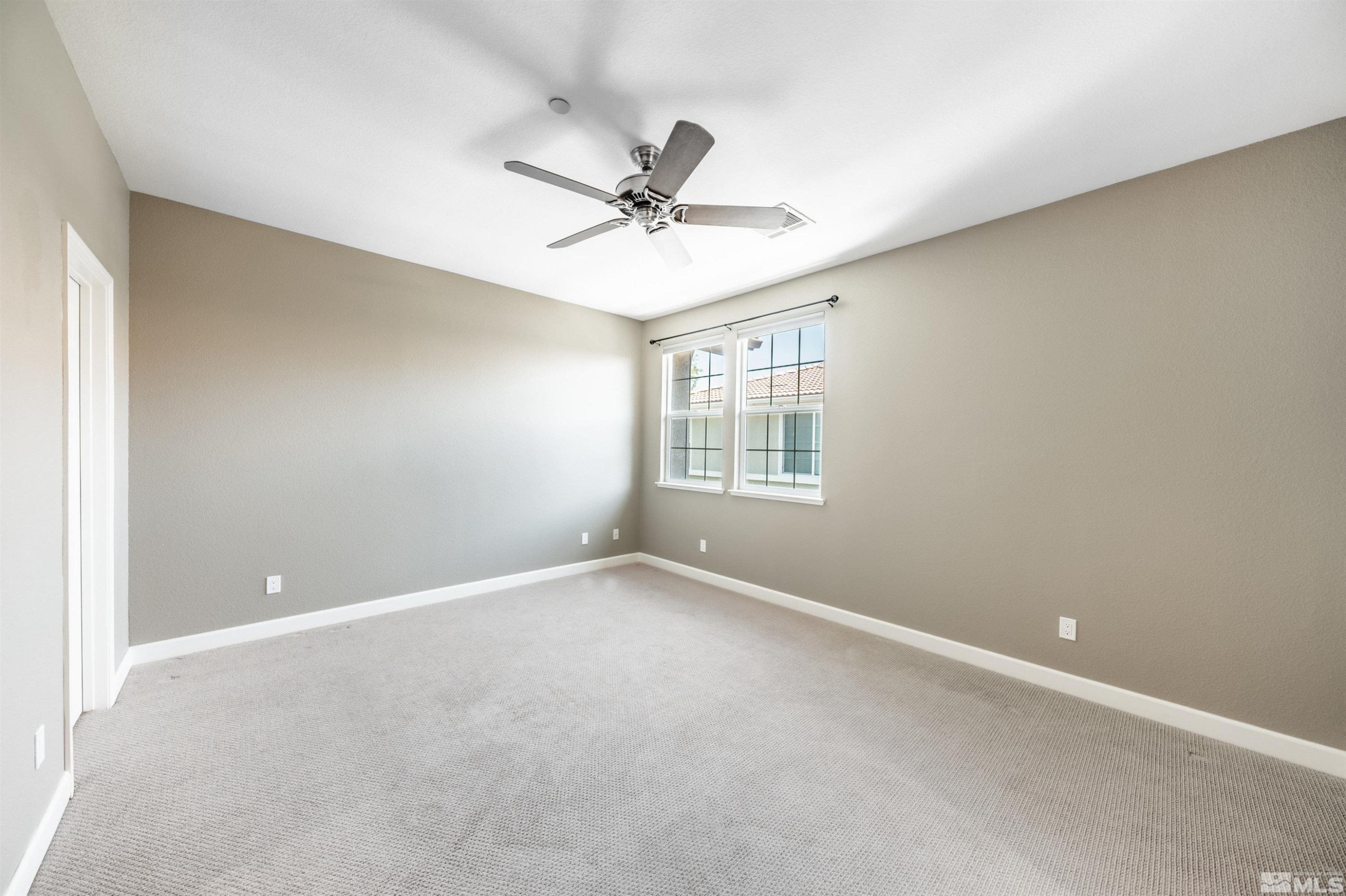 1835 Wind Ranch Road, Unit B Reno, NV 89521 - Photo 20 of 38 an empty room with a window and a fan