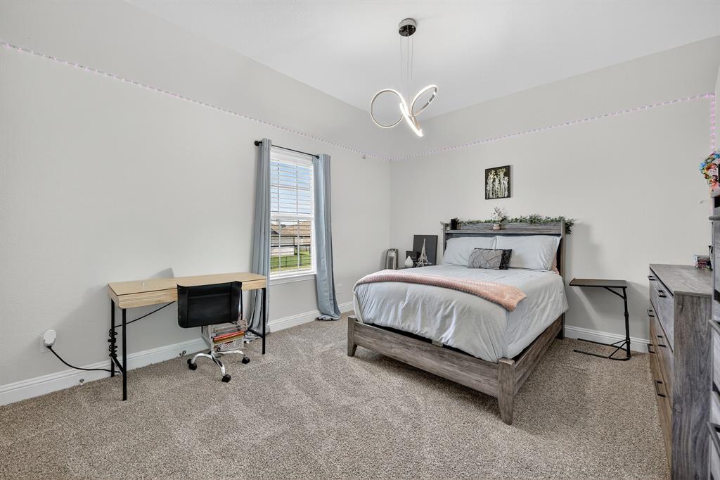 1420 Wolf Ridge Run Gunter, TX 75058 - Photo 11 of 40 a bedroom with a bed and a chair