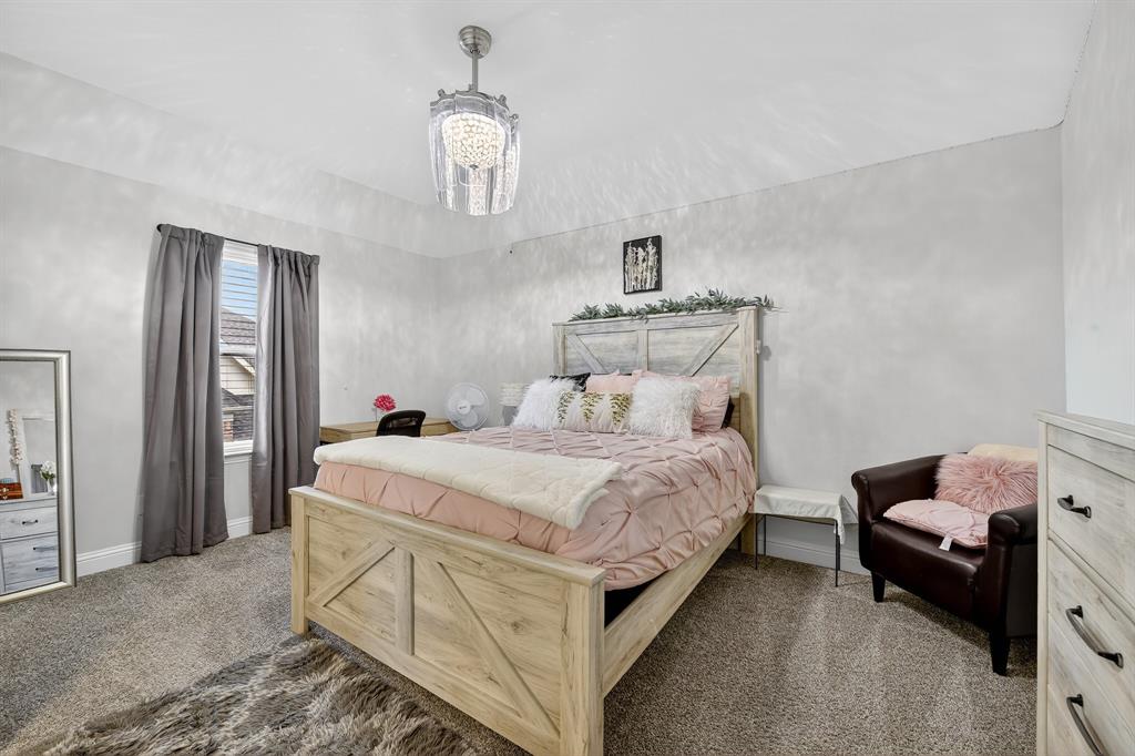 1420 Wolf Ridge Run Gunter, TX 75058 - Photo 12 of 40 a bedroom with bed and window