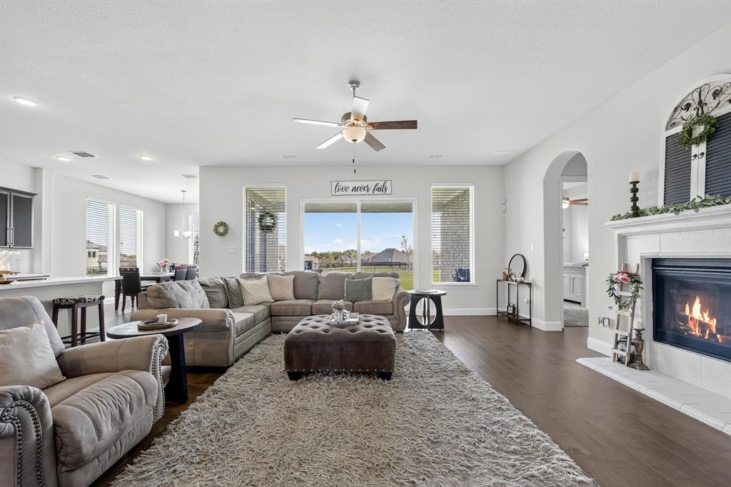 1420 Wolf Ridge Run Gunter, TX 75058 - Photo 18 of 40 a living room with furniture and a fireplace