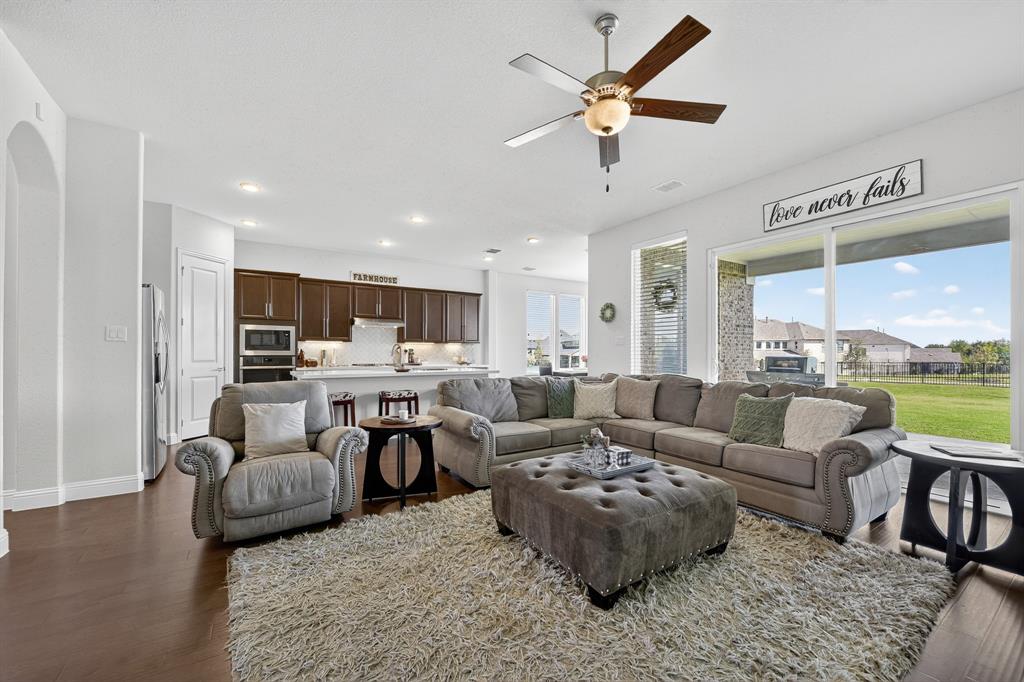 1420 Wolf Ridge Run Gunter, TX 75058 - Photo 19 of 40 a living room with furniture kitchen view and a large window