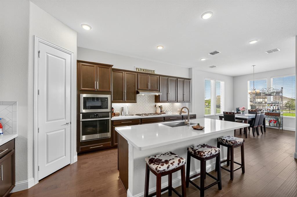 1420 Wolf Ridge Run Gunter, TX 75058 - Photo 26 of 40 a kitchen with refrigerator and chairs