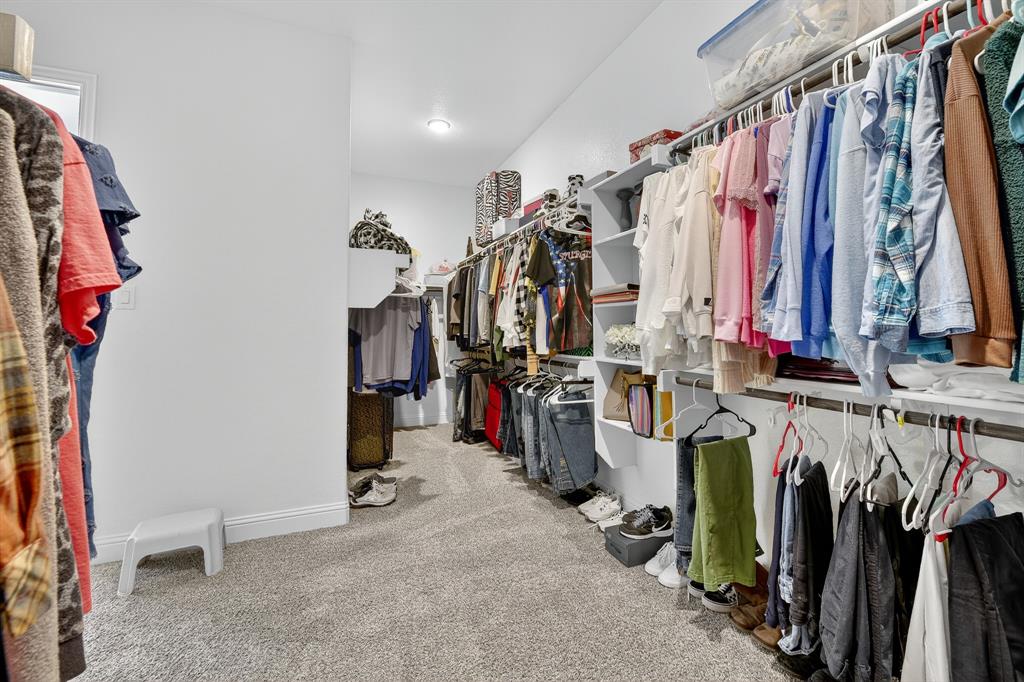 1420 Wolf Ridge Run Gunter, TX 75058 - Photo 33 of 40 a view of walk in closet with clothes
