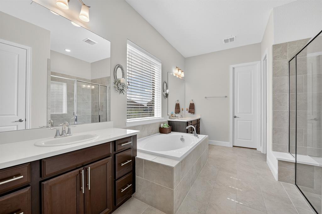 1420 Wolf Ridge Run Gunter, TX 75058 - Photo 34 of 40 a en suite bathroom with double sink and mirror