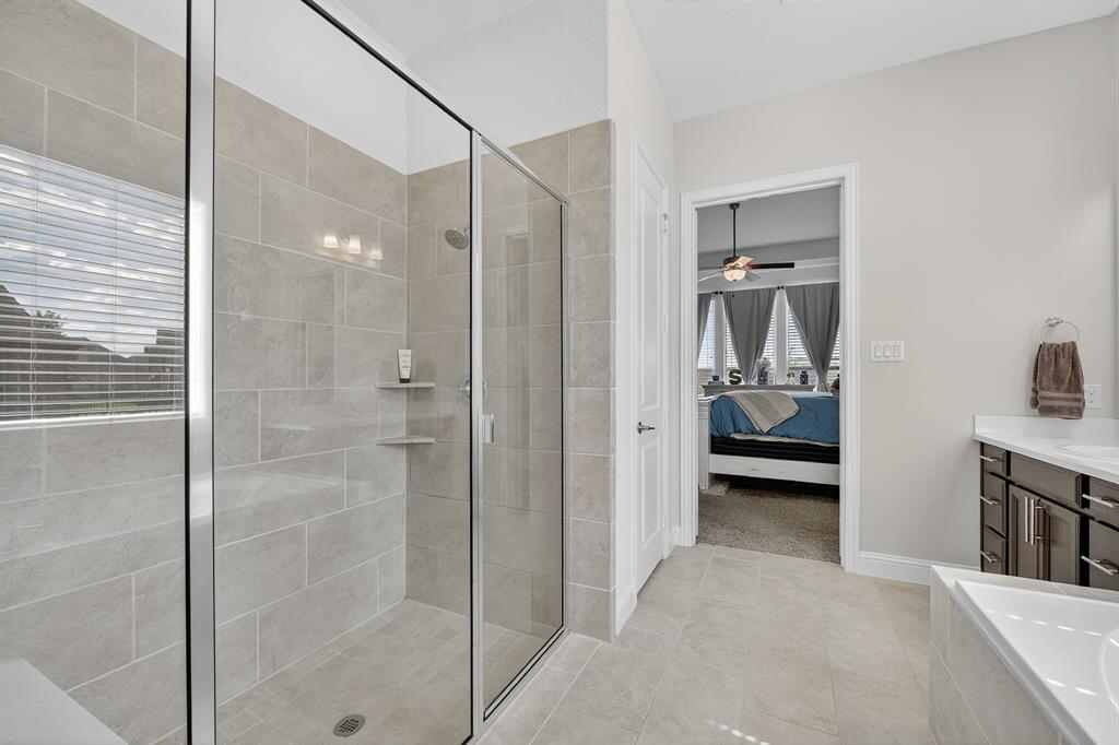 1420 Wolf Ridge Run Gunter, TX 75058 - Photo 35 of 40 a bathroom with a tub and a glass door shower