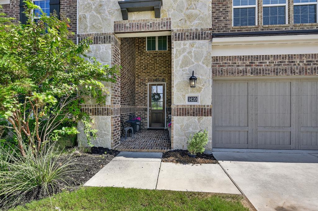1420 Wolf Ridge Run Gunter, TX 75058 - Photo 8 of 40 a front view of a house with a garden