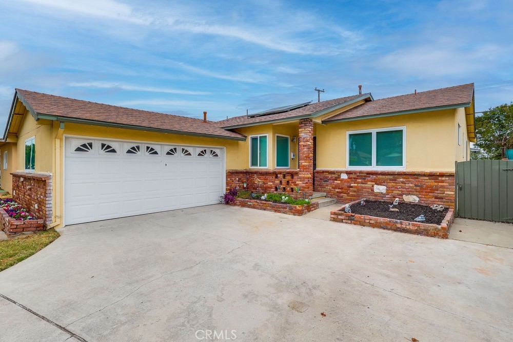 a front view of a house with yard and garage